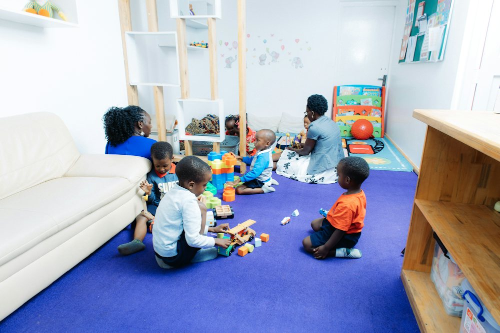 Children playing with toys on a classroom carpet